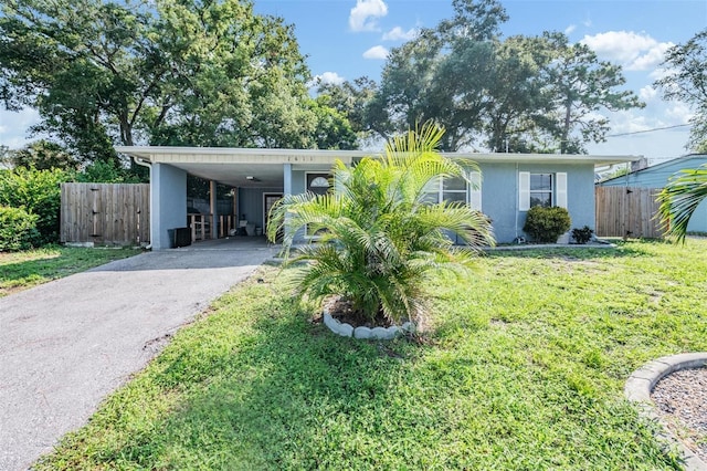 1611 Stevenson Dr, Clearwater, FL 33755 - view of front of property featuring asphalt driveway, stucco siding, and an attached carport
