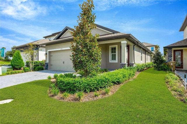 view of side of property with a garage, stucco siding, decorative driveway, and a yard