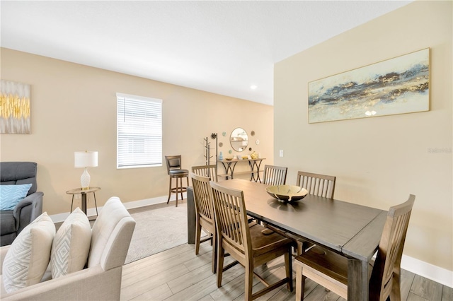 dining space featuring recessed lighting, baseboards, and wood finished floors