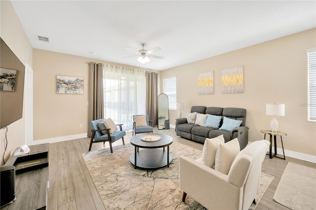 living room featuring ceiling fan and light hardwood / wood-style floors