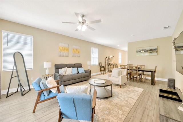 living room with ceiling fan and light hardwood / wood-style floors