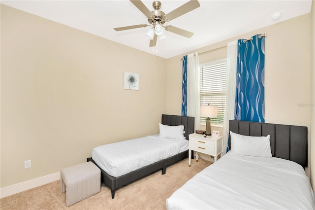 bedroom featuring light colored carpet and ceiling fan