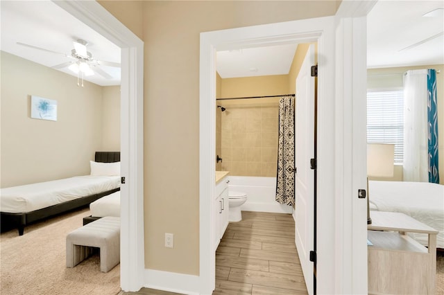 bathroom featuring ceiling fan, wood-type flooring, shower / bathtub combination with curtain, and toilet