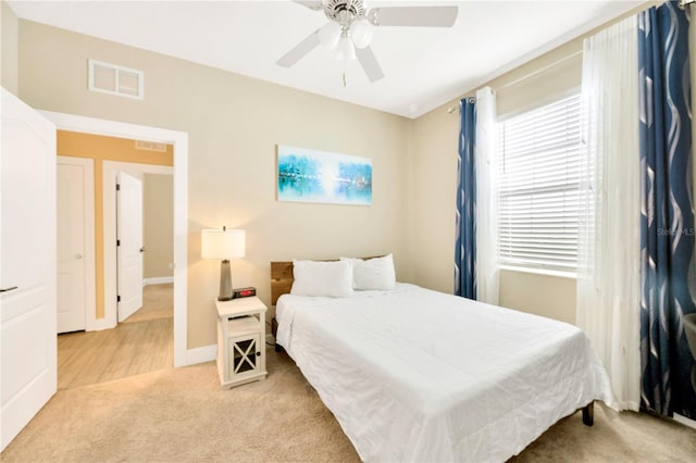 bedroom featuring ceiling fan and light carpet