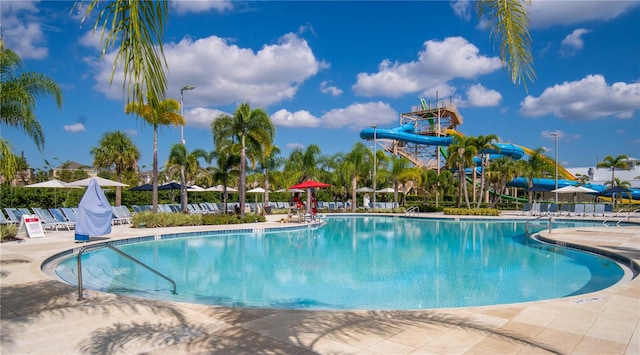 view of swimming pool with a patio area and a water slide