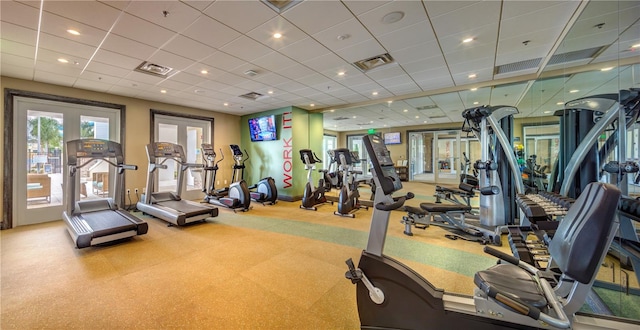 workout area featuring french doors and a drop ceiling