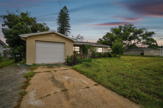 ranch-style home featuring a lawn