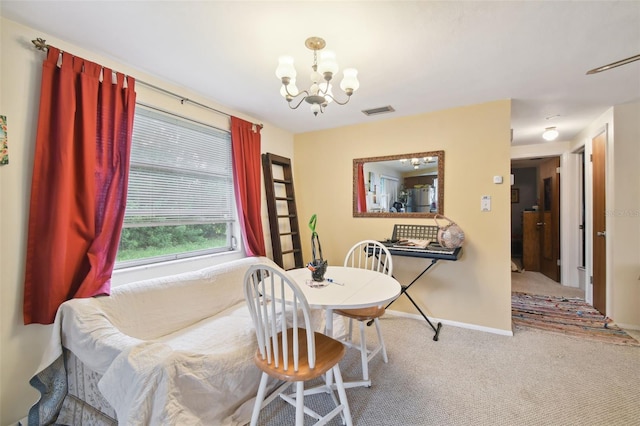 carpeted dining space featuring an inviting chandelier