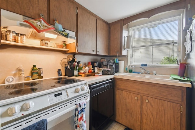 kitchen featuring light tile patterned floors, dishwasher, sink, and white range with electric cooktop