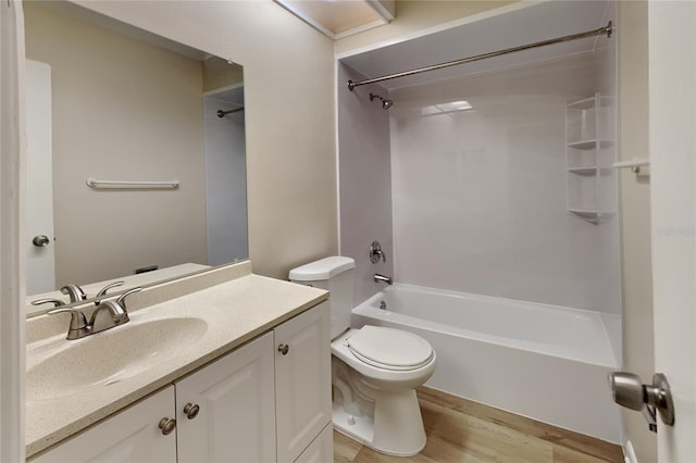 full bathroom featuring wood-type flooring, vanity, tub / shower combination, and toilet