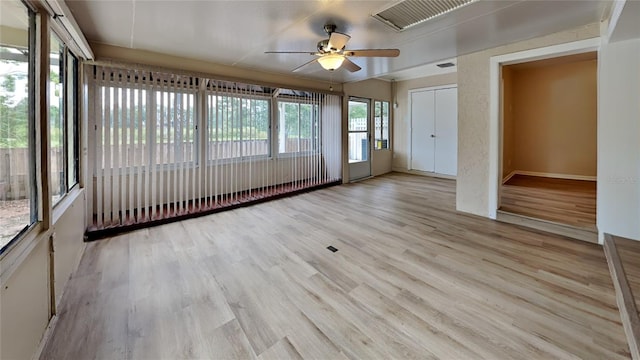 interior space with ceiling fan