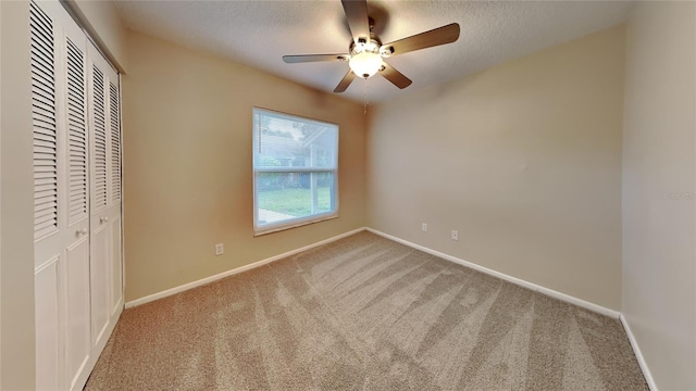 unfurnished bedroom with a closet, ceiling fan, and light colored carpet