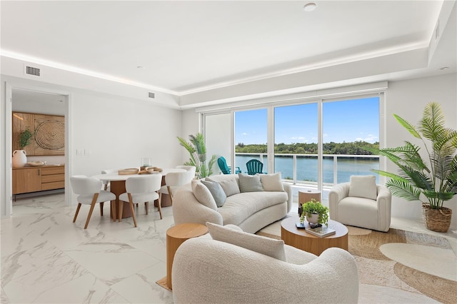 living room with a water view and light tile patterned floors