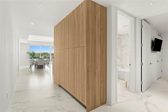 hall featuring light tile patterned flooring