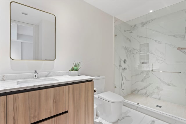 bathroom with a shower with shower door, toilet, vanity, and tile patterned floors