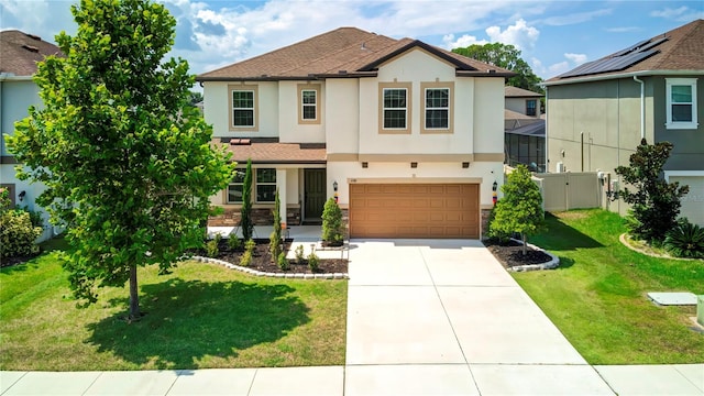 view of front of house featuring a garage and a front lawn