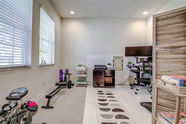 home office featuring concrete floors and a healthy amount of sunlight