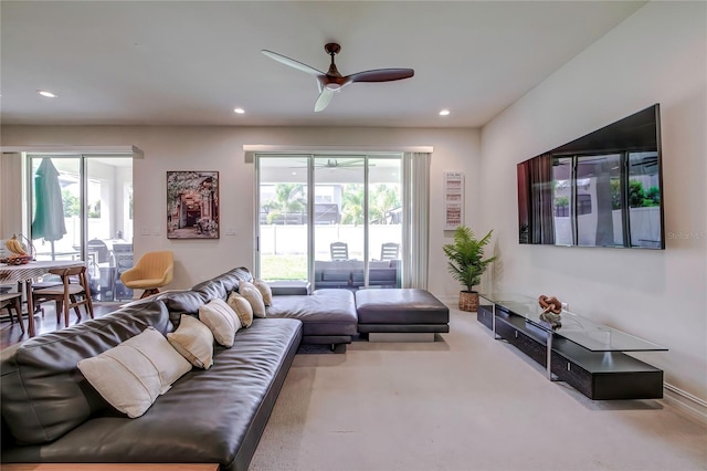 living room featuring ceiling fan and carpet flooring