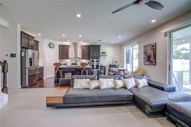 living room with ceiling fan and light wood-type flooring