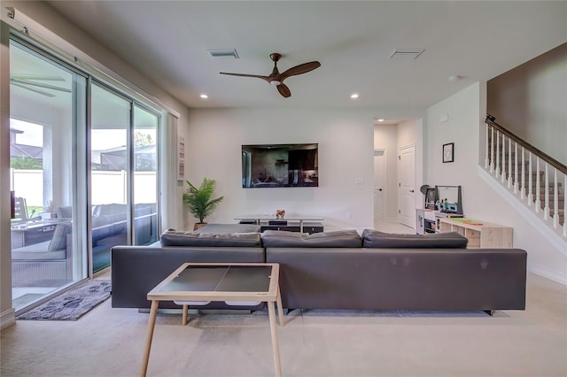 carpeted living room featuring ceiling fan