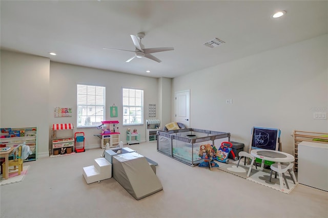 playroom featuring ceiling fan and light carpet