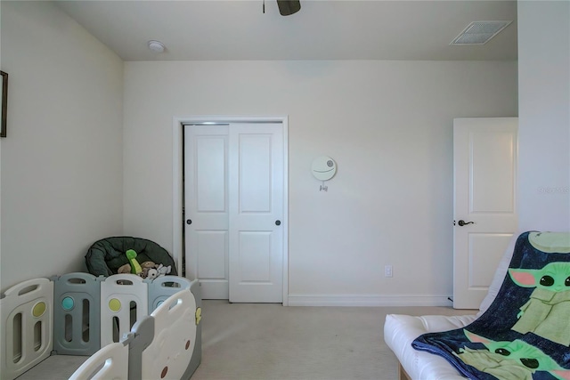 carpeted bedroom with a closet and ceiling fan