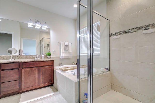 bathroom with tile patterned flooring, plus walk in shower, and vanity