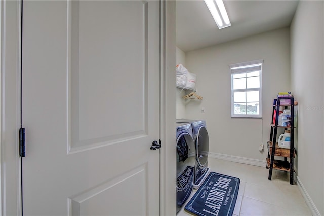 laundry area with light tile patterned flooring and independent washer and dryer