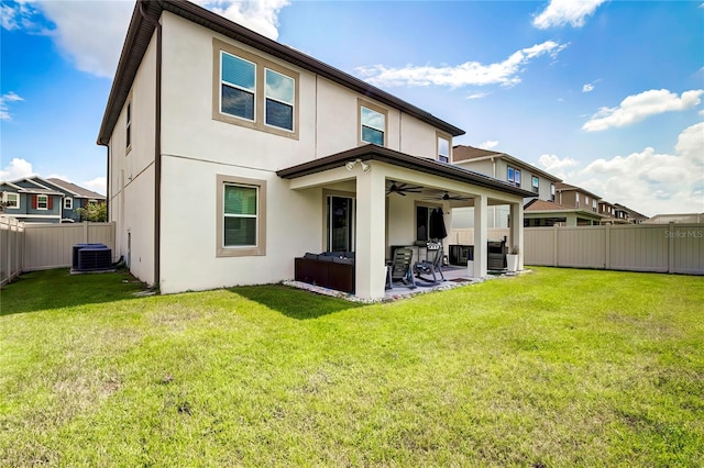 back of house with a patio area, a yard, central AC, and ceiling fan