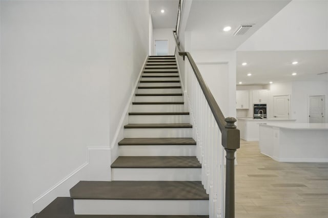 stairs with hardwood / wood-style floors