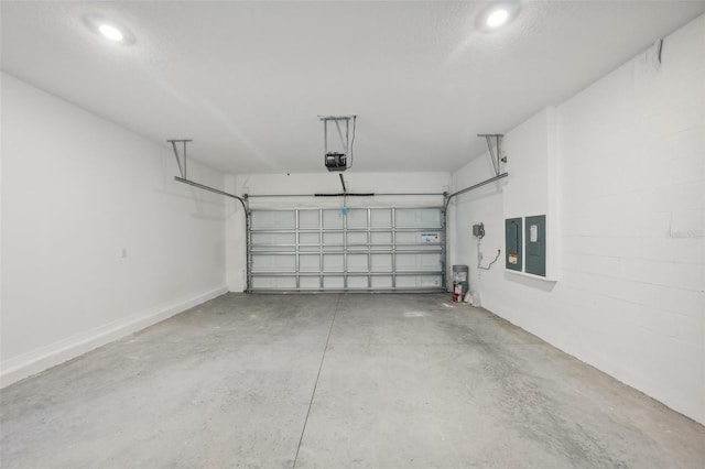 garage with a garage door opener and electric panel