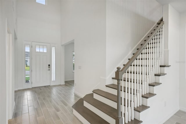 entrance foyer with light hardwood / wood-style flooring and a high ceiling