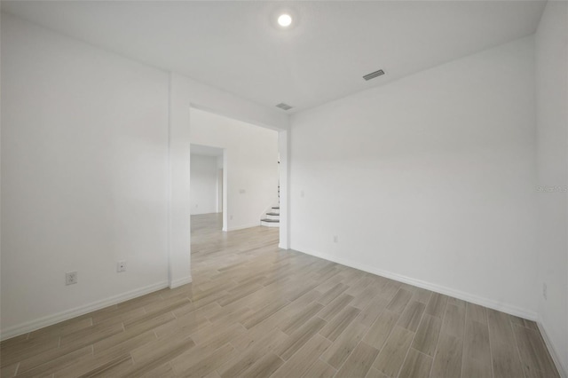 empty room with light hardwood / wood-style flooring