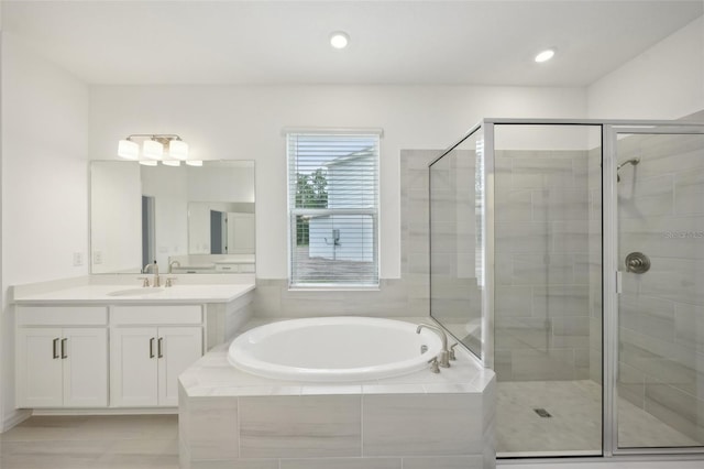 bathroom featuring vanity and separate shower and tub