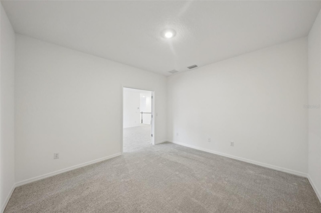 unfurnished room featuring light colored carpet