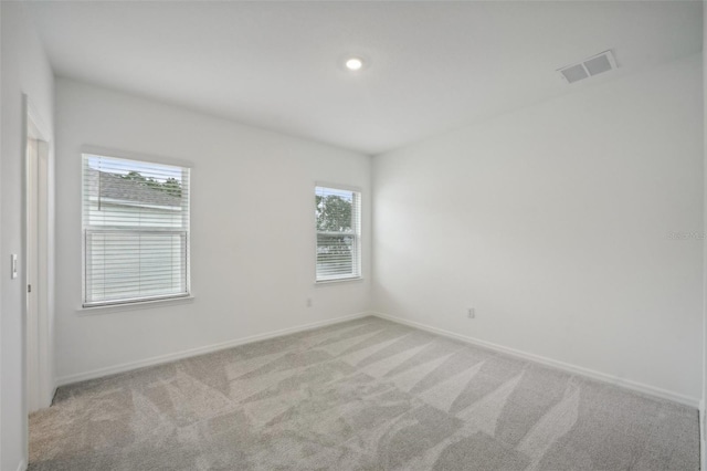 carpeted empty room with plenty of natural light