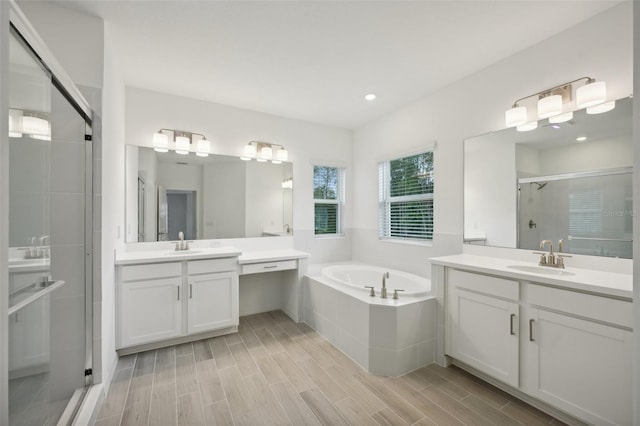 bathroom featuring vanity, wood-type flooring, and independent shower and bath