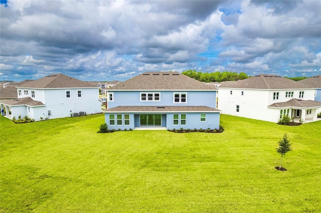 back of house with a lawn