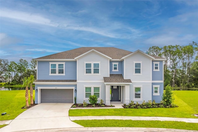 view of front of home with a garage, concrete driveway, a front yard, and roof with shingles