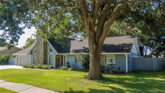 view of front facade with a garage and a front lawn