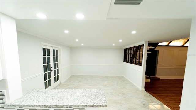 spare room featuring ornamental molding and french doors