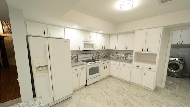 kitchen featuring white appliances, light tile patterned flooring, washer / clothes dryer, and tasteful backsplash