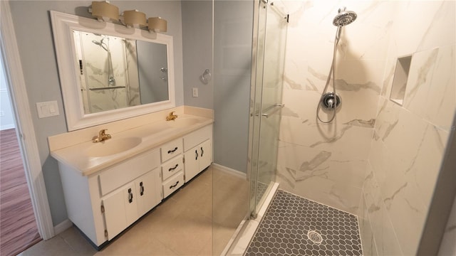 bathroom featuring tile patterned flooring, double sink vanity, and an enclosed shower