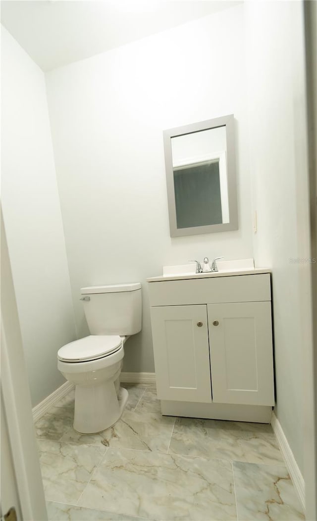 bathroom featuring toilet and vanity