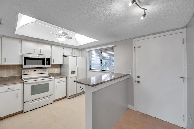 kitchen featuring white appliances, ceiling fan, backsplash, a textured ceiling, and white cabinets