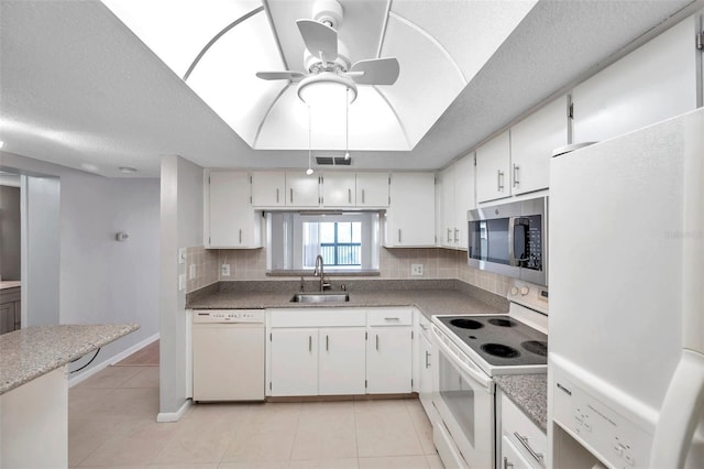 kitchen featuring white cabinetry, white appliances, sink, and light tile patterned floors