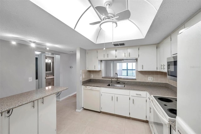 kitchen featuring sink, white appliances, ceiling fan, white cabinetry, and tasteful backsplash