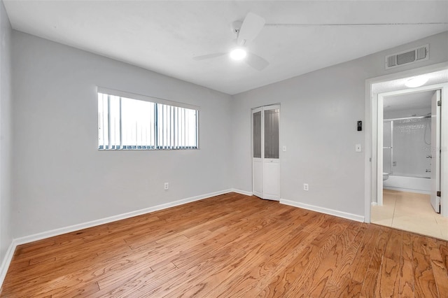 unfurnished bedroom with ceiling fan and light wood-type flooring