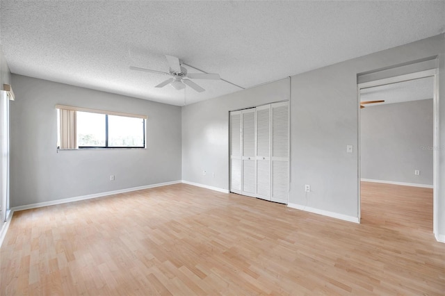 unfurnished bedroom with ceiling fan, light hardwood / wood-style floors, and a textured ceiling