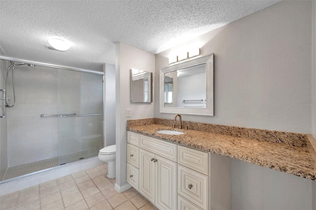 bathroom with vanity, a shower with shower door, and toilet